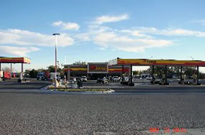 A Love's truck stop with fuel canopies at dusk.